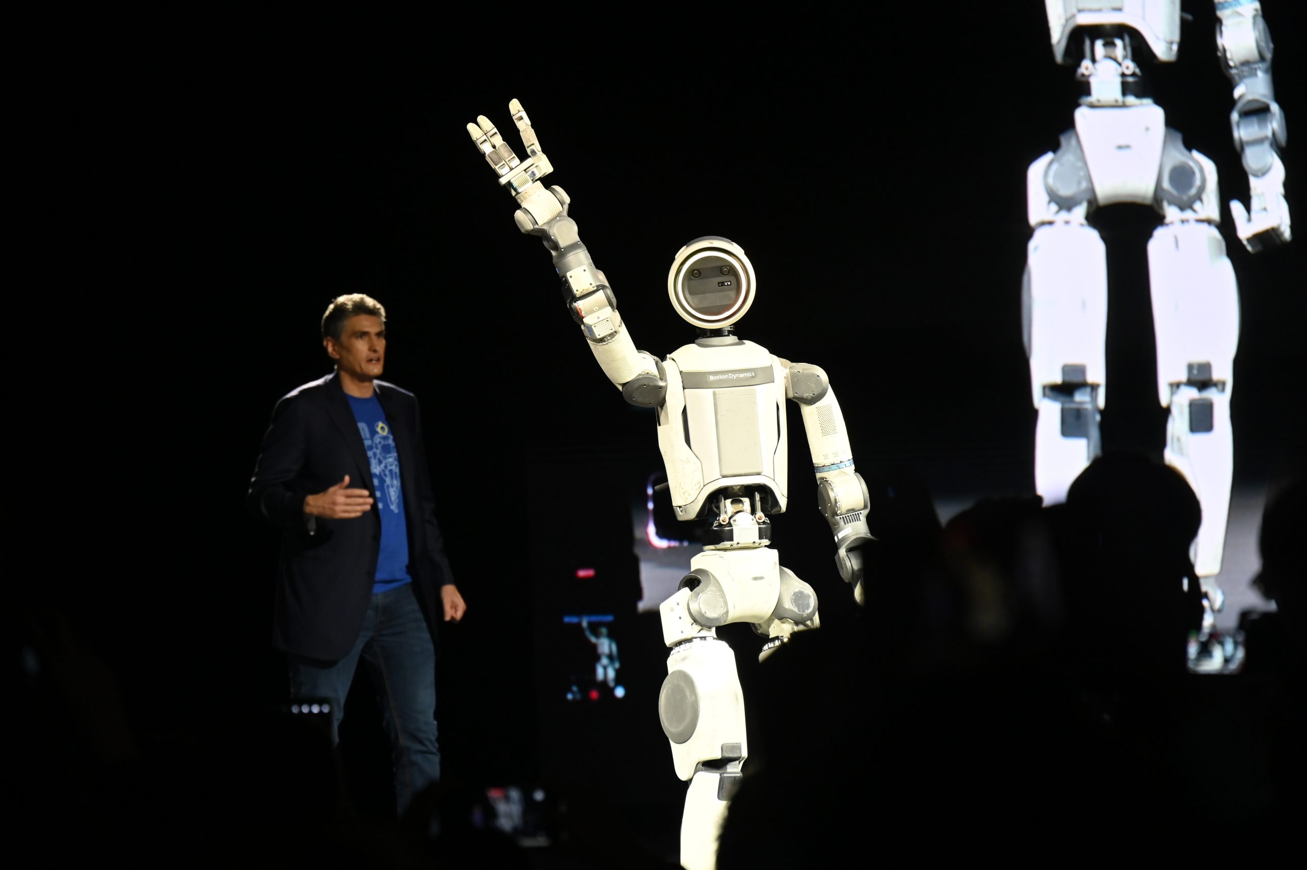 記者会見で手を振るアトラス