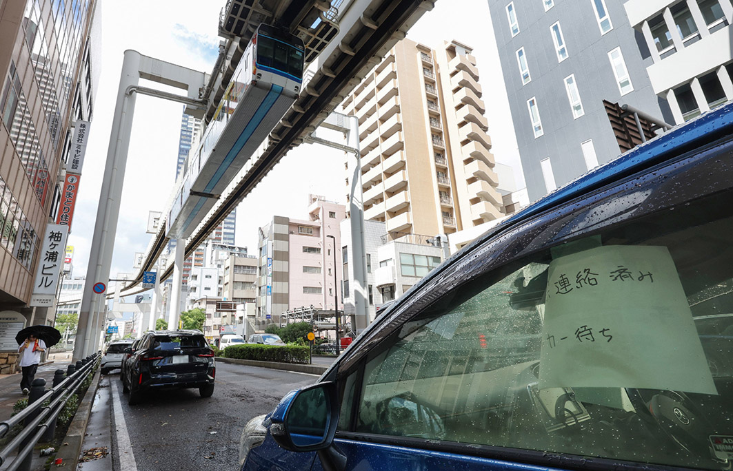 「レッカー待ち」の張り紙が掲示された車。14日午後、千葉市中央区にて(時事)