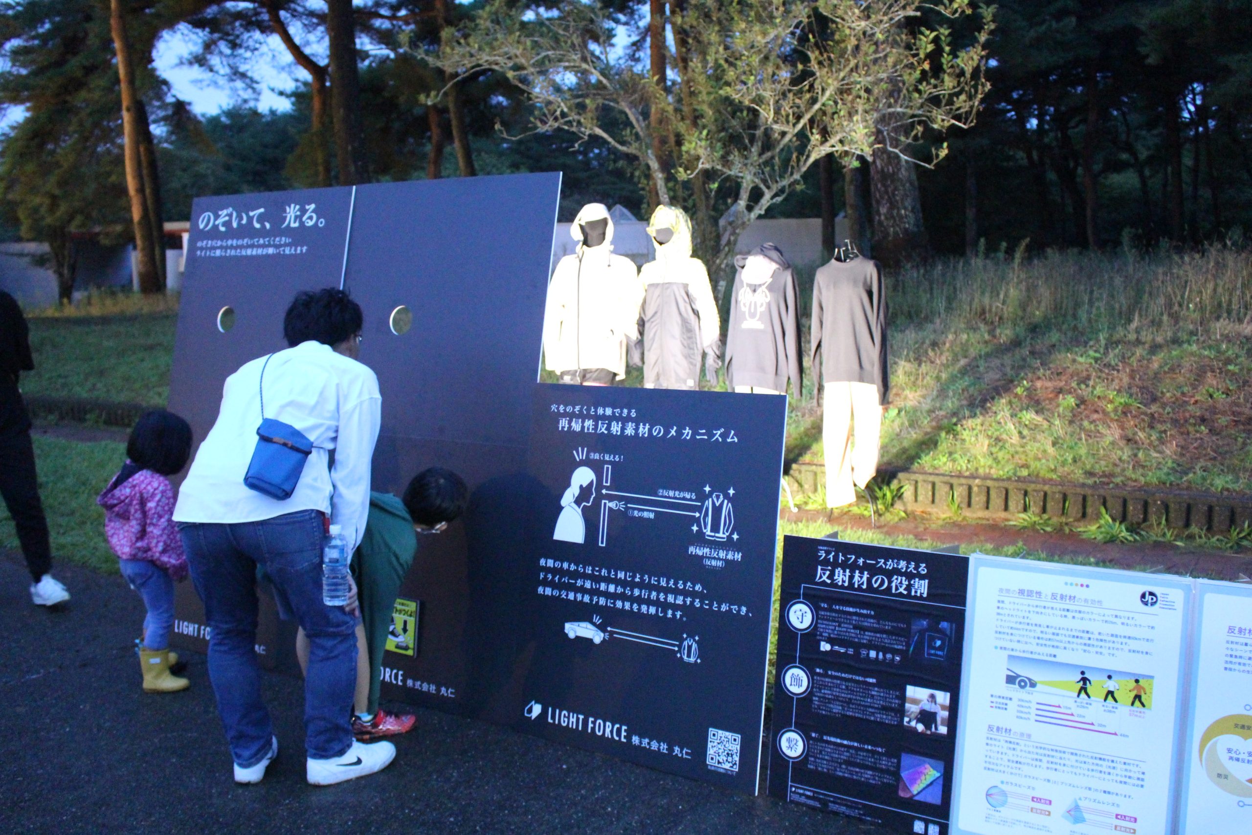 反射材をあしらった衣類に光を当てて有効性をPR